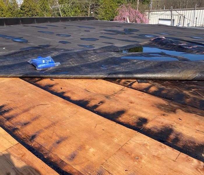 Damaged commercial roof with tarp 