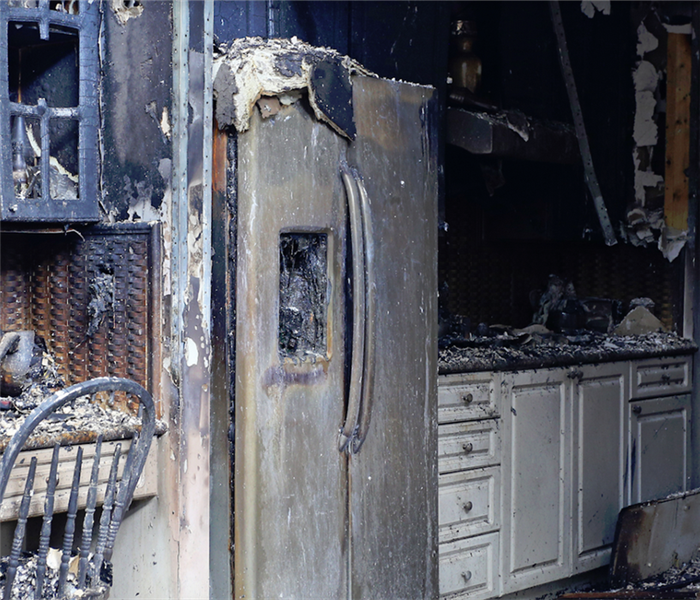 a fire damaged kitchen with debris everywhere