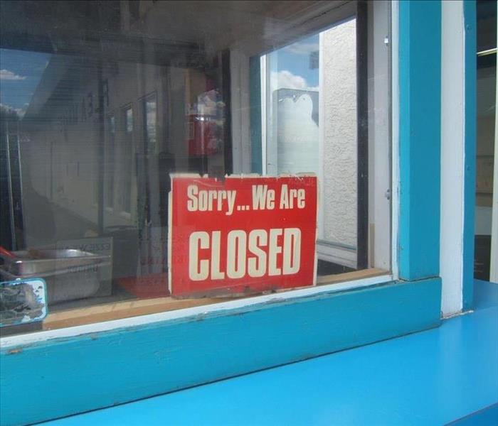 shop window with a sorry were closed sign