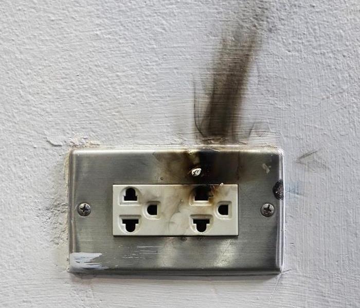 outlet in wall with smoke damage line
