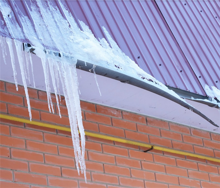icicles hanging off of the edge of a roof