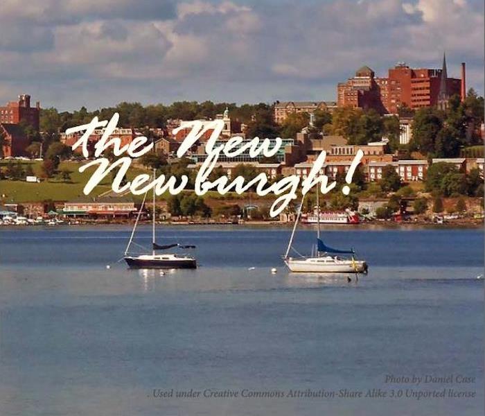 Sail boats on the water in front of a town with a caption of “The New Newburgh!”