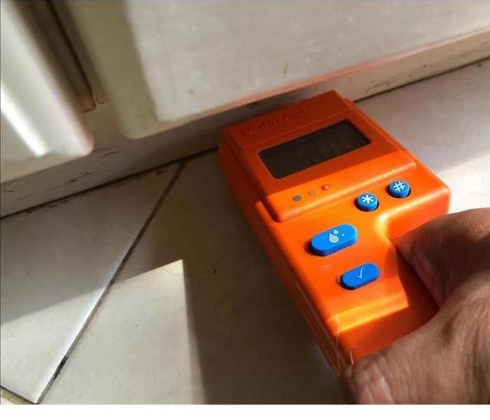 moisture meter checking wall